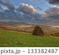 Traditional haystack standing on autumn rural hillside landscape 133382487