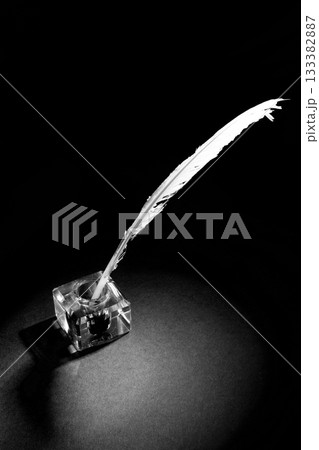 Old fountain pen with inkwell on a black textured background Old fountain pen with inkwell on a black textured background 133382887