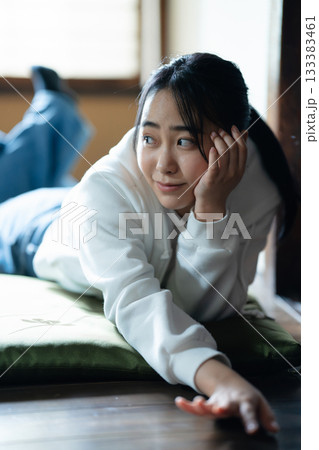 自宅で寝転んでくつろぐ女子高生 133383461