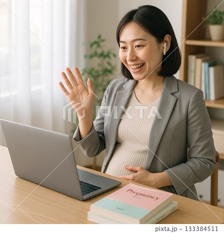 在宅勤務でビデオ通話をしながら手を振る妊娠中の女性 133384511