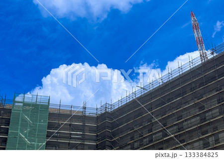 White fluffy Cumulus clouds forming over a construction site 133384825