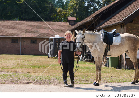 Girl with her horse in the countryside, a young rider and her equine friend, outdoor scene with natural light, equestrian lifestyle, rural setting, friendship and care. Girl with her horse in the countryside, a young rider and her equine friend, outdoor scene with natural light, equestrian lifestyle, rural setting, friendship and care. 133385537