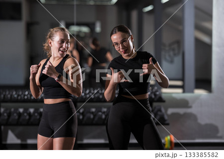 Friends celebrating fitness together in modern gym during afternoon workout session Friends celebrating fitness together in modern gym during afternoon workout session 133385582