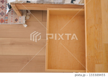 Empty drawer in a wooden dresser in a cozy room Empty drawer in a wooden dresser in a cozy room 133389455