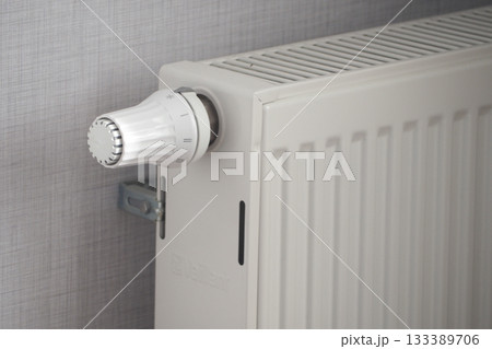 Heating system with adjustable thermostat in a cozy room Heating system with adjustable thermostat in a cozy room 133389706