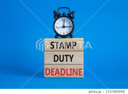 Stamp Duty Deadline symbol. Concept words Stamp Duty Deadline on wooden blocks. Beautiful blue background with alarm clock. Business and Stamp Duty Deadline concept. Copy space. Stamp Duty Deadline symbol. Concept words Stamp Duty Deadline on wooden blocks. Beautiful blue background with alarm clock. Business and Stamp Duty Deadline concept. Copy space. 133390946