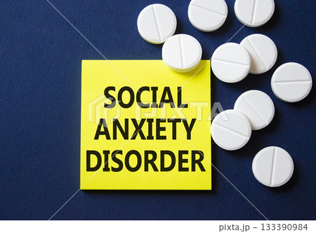 Social Anxiety Disorder symbol. Concept words Social Anxiety Disorder on yellow note. Beautiful deep blue background with pills. Healthcare and Social Anxiety Disorder concept. Copy space. Social Anxiety Disorder symbol. Concept words Social Anxiety Disorder on yellow note. Beautiful deep blue background with pills. Healthcare and Social Anxiety Disorder concept. Copy space. 133390984