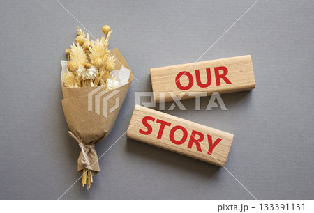 Our story symbol. Wooden blocks with words Our story. Beautiful grey background. Business and Our story concept. Copy space. Our story symbol. Wooden blocks with words Our story. Beautiful grey background. Business and Our story concept. Copy space. 133391131
