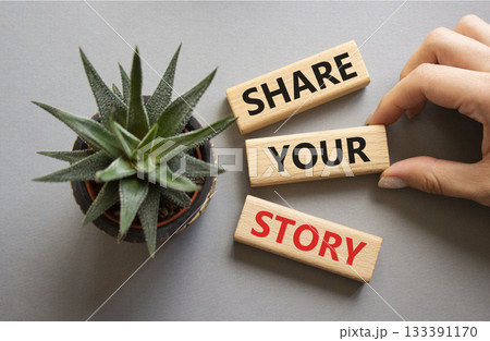 Share your story symbol. Wooden blocks with words Share your story. Beautiful grey background with succulent plant. Businessman hand. Business and Share your story concept. Copy space. Share your story symbol. Wooden blocks with words Share your story. Beautiful grey background with succulent plant. Businessman hand. Business and Share your story concept. Copy space. 133391170