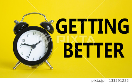 Getting better symbol. Beautiful yellow background with alarm clock. Business and Getting better concept. Copy space. Getting better symbol. Beautiful yellow background with alarm clock. Business and Getting better concept. Copy space. 133391223