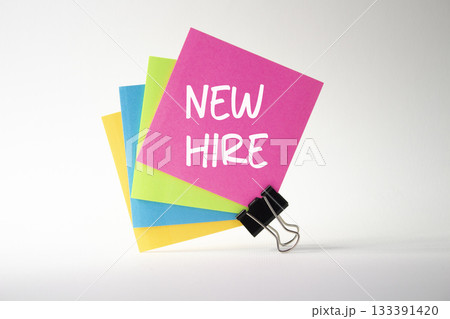 New Hire symbol. Pink sticky note with concept words New Hire. Beautiful white background. Business and New Hire concept. Copy space. New Hire symbol. Pink sticky note with concept words New Hire. Beautiful white background. Business and New Hire concept. Copy space. 133391420