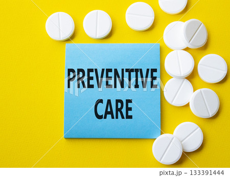 Preventive Care symbol. Concept word Preventive Care on blue note. Beautiful yellow background with pills. Medicine and Preventive Care concept. Copy space 133391444