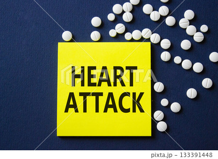 Heart Attack symbol. Concept word Heart Attack on yellow note. Beautiful deep blue background with pills. Medicine and Heart Attack concept. Copy space 133391448
