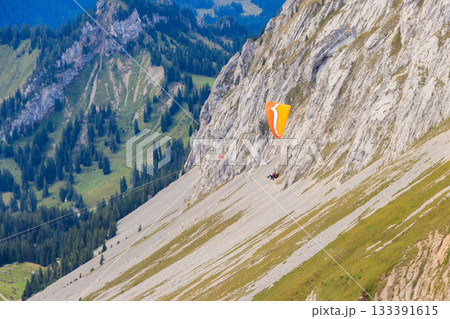 Paragliders flying from Pilatus mountain in Swiss Alps, Switzerland. Concept of active lifestyle and extreme sport adventure 133391615