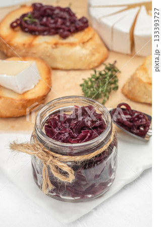 Homemade caramelized red onion jam in a glass jar with rustic twine, served alongside toasted bread, brie cheese and fresh thyme Homemade caramelized red onion jam in a glass jar with rustic twine, served alongside toasted bread, brie cheese and fresh thyme 133393727