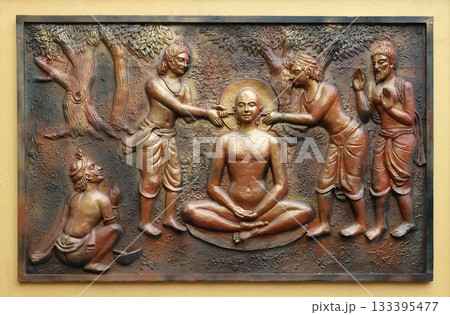 The pegs are being extracted with the help incers, Street bass relief on the wall of Jain Temple (also called Parshwanath Temple) in Kolkata, West Bengal, India 133395477