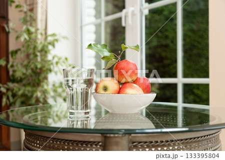 Glass of Water and Apples Detox and Hydration Concept 133395804