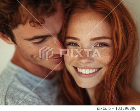 Young man kissing his ginger girlfriend 133396896