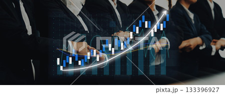 Business professionals in suits analyzing stock market trends, with a graphical representation of rising data charts illustrating growth in financial investments. Axiom Business professionals in suits analyzing stock market trends, with a graphical representation of rising data charts illustrating growth in financial investments. Axiom 133396927