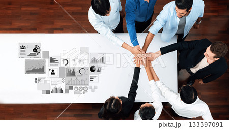 Team Collaboration at a Conference Table with Graphs and Data Visualizations in a Modern Office Setting Trope 133397091