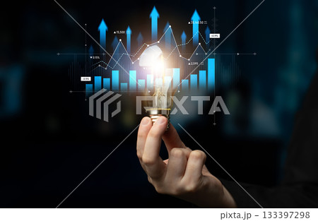 Light Bulb in Hand Overlapping Digital Graphs with Upward Trend Indicating Innovation, Bright Ideas, Growth and Business Strategy in Modern Concept Scalp Light Bulb in Hand Overlapping Digital Graphs with Upward Trend Indicating Innovation, Bright Ideas, Growth and Business Strategy in Modern Concept Scalp 133397298
