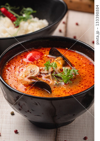 Spicy tom yam soup with rice served together Spicy tom yam soup with rice served together 133398884