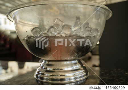A glass bowl with ice. Ice cubes in a glass plate 133400209