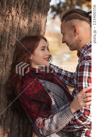 young couple in love walking and having fun in autumn park 133400356