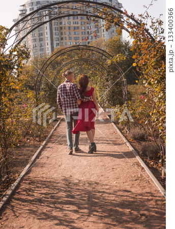 Happy young couple in love spending time together in autumn park hugging Happy young couple in love spending time together in autumn park hugging 133400366