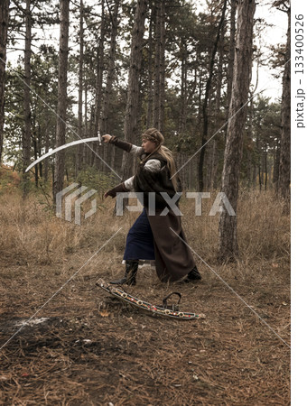 warrior girl with sword in hands in the forest 133400526