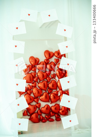 A tall mirror in the room is decorated with letters with hearts 133400666