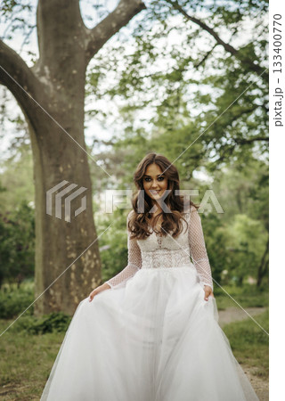 young girl bride in a white dress in a spring forest on a wedding day young girl bride in a white dress in a spring forest on a wedding day 133400770