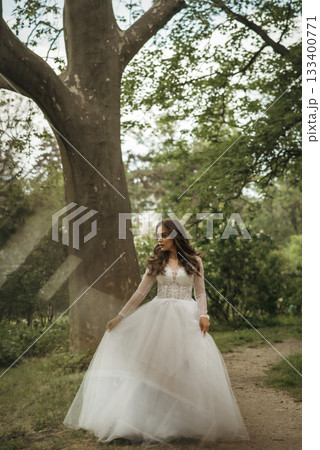 young girl bride in a white dress in a spring forest on a wedding day young girl bride in a white dress in a spring forest on a wedding day 133400771