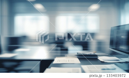 Abstract blurred office interior room. The sleek and modern office furniture, with a desk cluttered with papers and a state-of-the-art computer 133403972