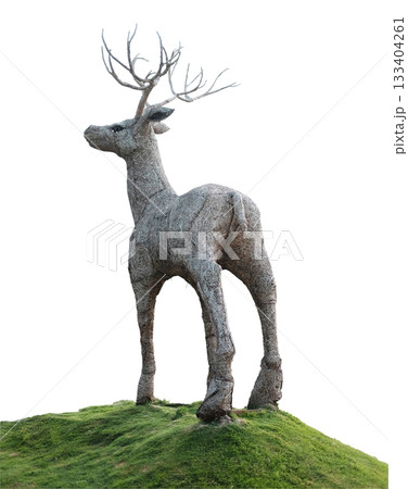 The deer puppet is made from woven straw into the shape of a large deer on green grass isolated on white background with clipping path 133404261