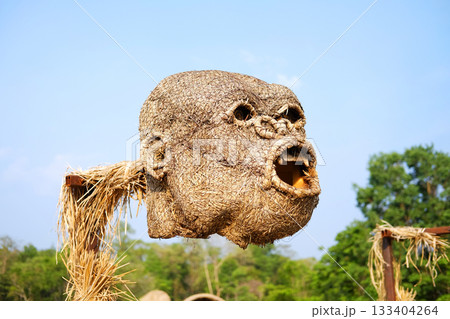 The head of monkey puppet is made from woven straw into the shape of a large gorilla on blue sky in Thailand The head of monkey puppet is made from woven straw into the shape of a large gorilla on blue sky in Thailand 133404264