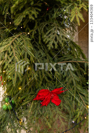 Christmas tree with many ornaments and pine cones. Christmas tree with many ornaments and pine cones. 133404369