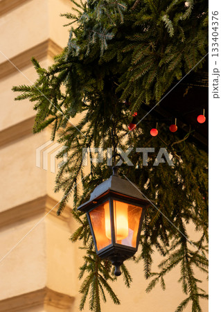 Christmas tree with many ornaments and pine cones. 133404376