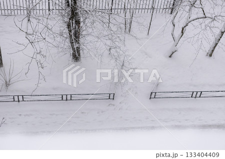 snow covered urban landscape with a tall building in the background. snow covered urban landscape with a tall building in the background. 133404409