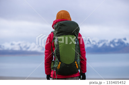 Backpacking woman hiking on high altitude mountain top 133405452