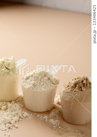 Protein powder in scoops. Different flavours of whey protein powder, copy space. 133406425