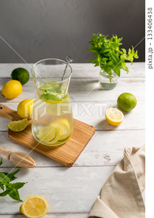A glass jug with lemonade with lemons, limes and fresh mint, summer drink, copy space 133406438