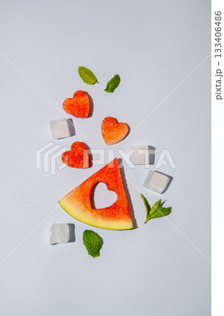 Watermelon triangle slice and heart isolated on blue background Watermelon triangle slice and heart isolated on blue background 133406486