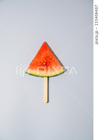 Watermelon triangle slice isolated on blue background 133406487