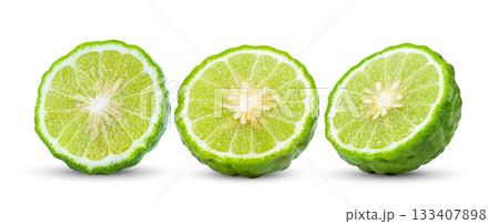 A half of bergamot or kaffir with leaf isolated on white background. A half of bergamot or kaffir with leaf isolated on white background. 133407898