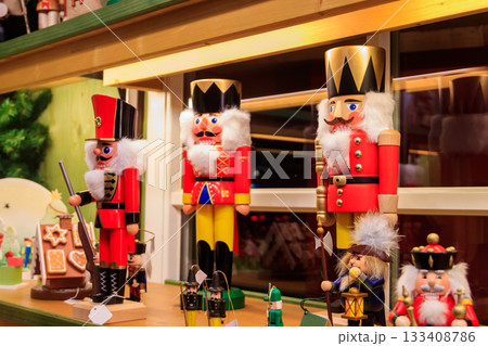 Variety of Christmas wooden nutcrackers on the shelves in a store. Festive Christmas trade Variety of Christmas wooden nutcrackers on the shelves in a store. Festive Christmas trade 133408786