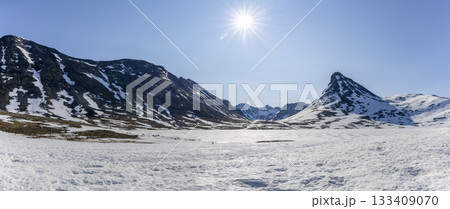 Snowy landscape in Leirdalen showcasing stunning peaks in Jotunheimen National Park on a clear day in spring 133409070
