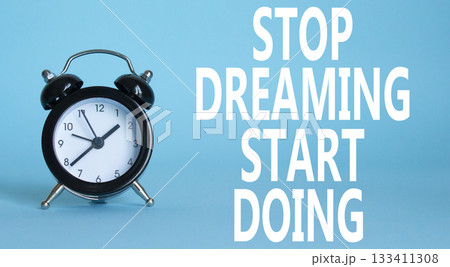 Stop Dreaming Start Doing symbol. Beautiful blue background with alarm clock. Business and Stop Dreaming Start Doing concept. Copy space. Stop Dreaming Start Doing symbol. Beautiful blue background with alarm clock. Business and Stop Dreaming Start Doing concept. Copy space. 133411308