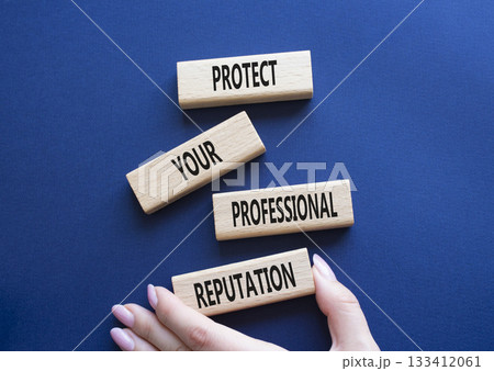 Professional Reputation symbol. Concept words Protect Your Professional Reputation on wooden blocks. Beautiful deep blue background. Businessman hand. Business concept. Copy space Professional Reputation symbol. Concept words Protect Your Professional Reputation on wooden blocks. Beautiful deep blue background. Businessman hand. Business concept. Copy space 133412061