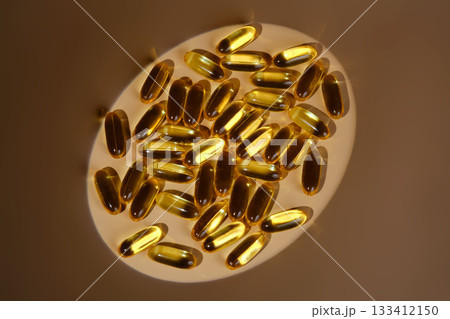 Omega 3 fish oil capsules scattered on surface Omega 3 fish oil capsules scattered on surface 133412150